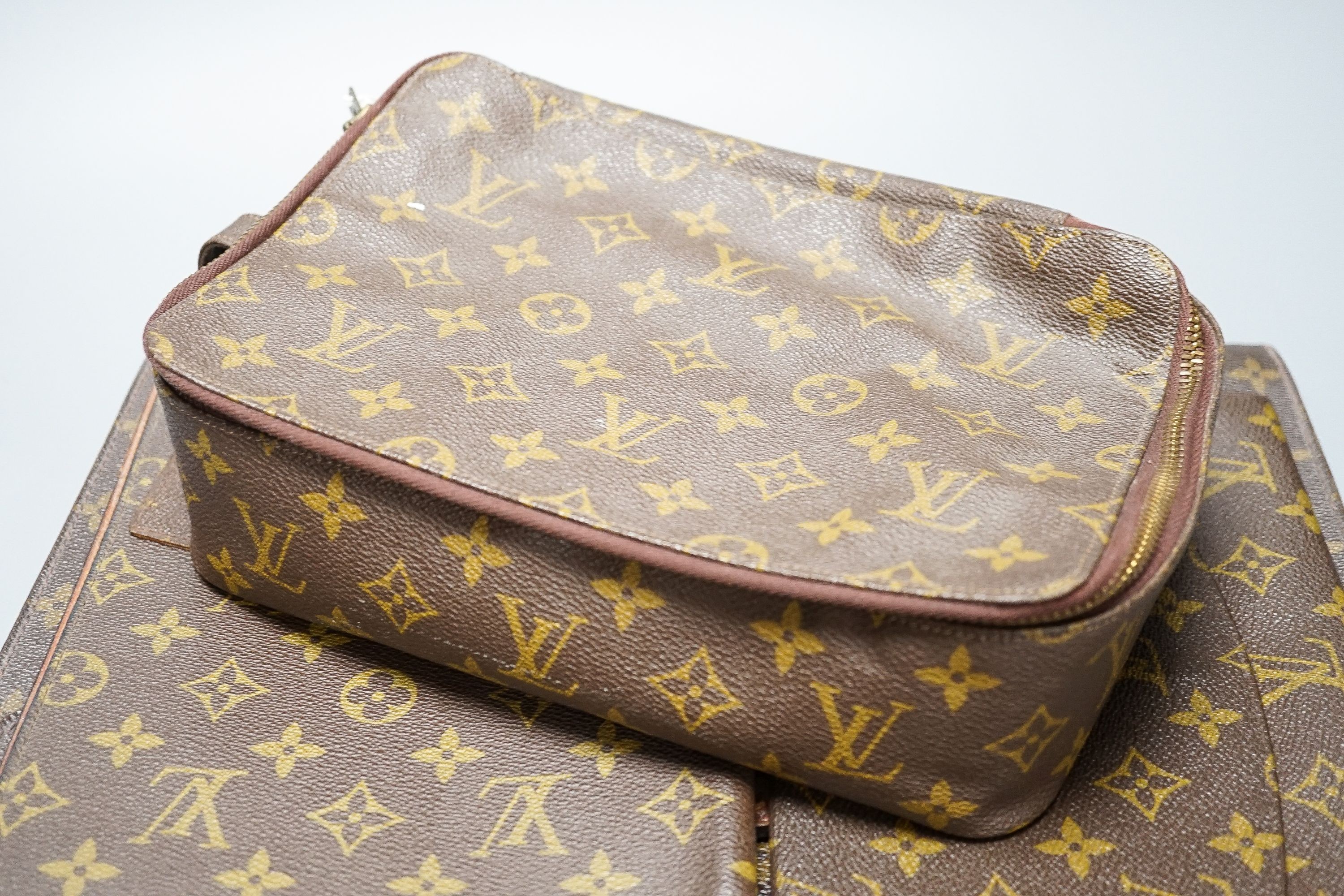 Five Pieces of Louis Vuitton to including a toilet bag, and two soft cases.
